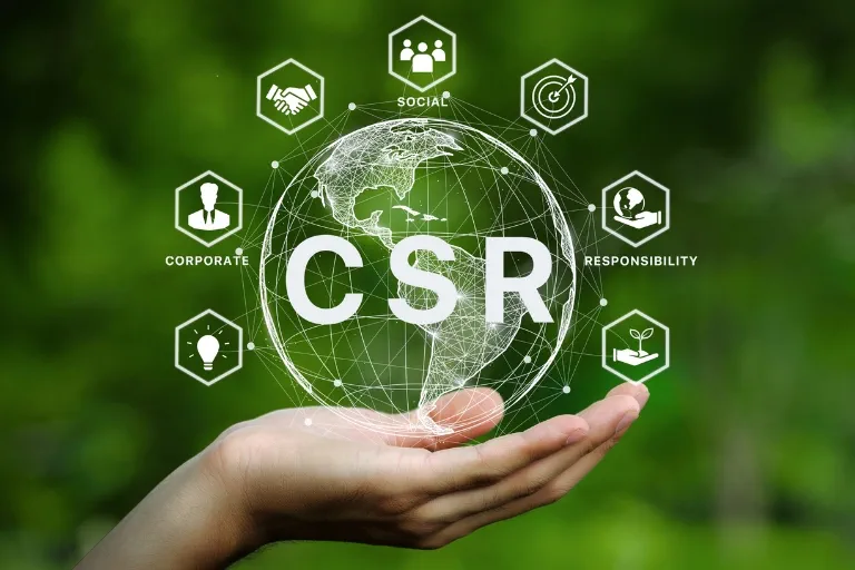 Corporate social responsibility graphic held in a hand